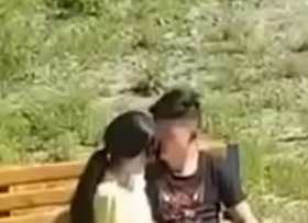 Oriental couple filmed nearly the public park